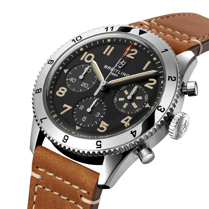 From brave first takeoffs to the birth of commercial air travel, Breitling’s history is inseparable from that of flight. In the 1930s, Breitling’s Huit Aviation department made its name inventing precision cockpit clocks. Two decades later, it introduced yet another novel flight instrument, this time in wearable form: the Ref. 765 AVI. That pioneering pilot’s watch provided the technical backdrop for today’s Classic AVI, a collection inspired by the rugged spirit of famed early aircraft.
The Classic AVI P-51 Mustang honors one of those legends. When the aircraft was built in a mere 120 days, even its developer North American Aviation, didn’t anticipate what a powerhouse it had on its hands. The P-51’s low-drag wings and engine-cooling system—considered experimental when the single-seat fighter first took off in 1940—gave it unprecedented speed and range. The addition of a Merlin engine, expanded the plane’s performance to high altitudes, making it the best all-purpose fighter of its time.
As a true pilot’s watch designed to withstand the rigors of a vintage cockpit, the Classic AVI P-51 Mustang features large, highly legible Arabic numerals on the dial and bezel.
The knurled bezel on the 42mm case provides optimal grip, even in a pilot’s gloved hands. Top-stitched calfskin straps give a nod to the seams found on classic flight gear, while the stainless-steel bracelet provides an elegant alternative. Pilots and other travelers will appreciate its legibility, wearability, and understated style. The engine of the Classic AVI is the COSC-certified Breitling Caliber 23 movement, which provides approximately 48-hours of power reserve.