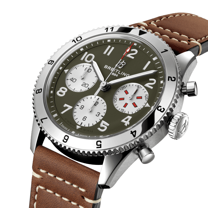 From brave first takeoffs to the birth of commercial air travel, Breitling’s history is inseparable from that of flight. In the 1930s, Breitling’s Huit Aviation department made its name inventing precision cockpit clocks. Two decades later, it introduced yet another novel flight instrument, this time in wearable form: the Ref. 765 AVI. That pioneering pilot’s watch provided the technical backdrop for today’s Classic AVI, a collection inspired by the rugged spirit of famed early aircraft.
The Classic AVI Curtiss P-40 Warhawk honors one of those legends. Conceived as a pursuit aircraft, the Curtiss P-40 Warhawk first flew in 1938 and quickly proved itself as a master of agility. It wasn’t just the plane’s capacity for pulling jaw-dropping turns that gave it an in-flight edge, its robust structure meant it could tolerate harsh weather conditions and even many mid-air collisions. The Warhawk’s defiant shark-mouth nose art sealed its reputation as the rebel of the skies.
As a true pilot’s watch designed to withstand the rigors of a vintage cockpit, the Classic AVI Curtiss P-40 Warhawk features large, highly legible Arabic numerals on the dial and bezel.
The knurled bezel on the 42mm case provides optimal grip, even in a pilot’s gloved hands. Top-stitched calfskin straps give a nod to the seams found on classic flight gear, while the stainless-steel bracelet provides an elegant alternative. Pilots and other travelers will appreciate its legibility, wearability, and understated style. The engine of the Classic AVI is the COSC-certified Breitling Caliber 23 movement, which provides approximately 48-hours of power reserve.