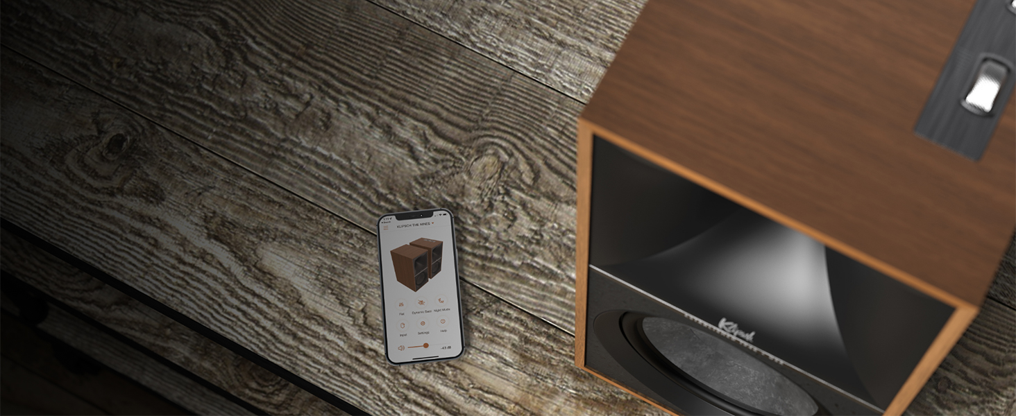 The Nines Walnut Beside Phone Klipsch App Open