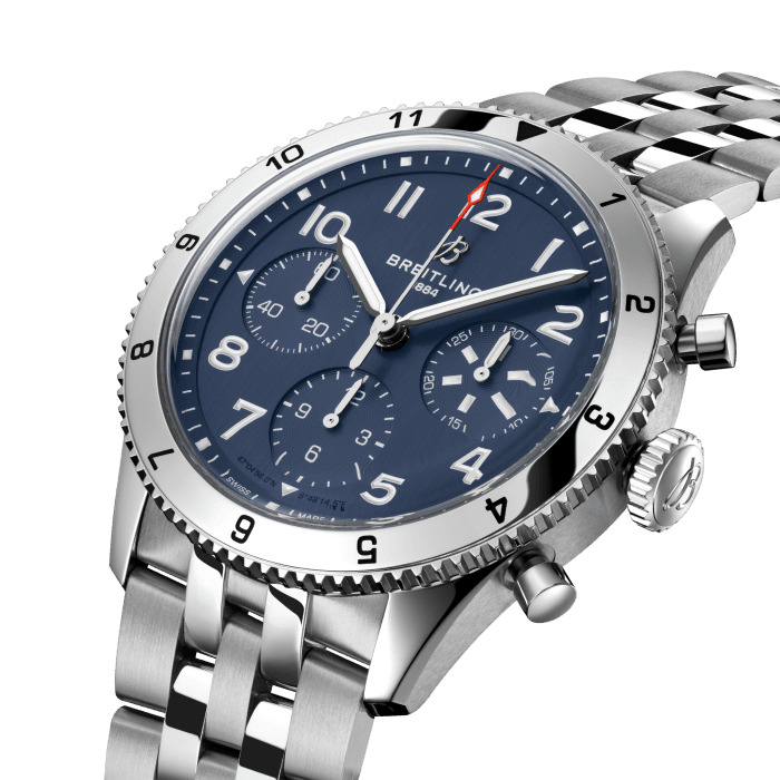 From brave first takeoffs to the birth of commercial air travel, Breitling’s history is inseparable from that of flight. In the 1930s, Breitling’s Huit Aviation department made its name inventing precision cockpit clocks. Two decades later, it introduced yet another novel flight instrument, this time in wearable form: the Ref. 765 AVI. That pioneering pilot’s watch provided the technical backdrop for today’s Classic AVI, a collection inspired by the rugged spirit of famed early aircraft.
The Classic AVI Tribute to Vought F4U Corsair honors one of those legends. As a WWII naval aircraft, the Vought F4U Corsair had to make tricky takeoffs and landings from carriers and remote landing strips. Speed and lift were of the essence, and the plane came through with flying colors, becoming the first single-engine fighter to crack the 400 mph (640 km/h) mark, while also providing an exceptional rate of climb. Its “bent-wing” design, oversized propeller and signature blue livery make it an emblem of aviation history. 
As a true pilot’s watch designed to withstand the rigors of a vintage cockpit, the Classic AVI Tribute to Vought F4U Corsair features large, highly legible Arabic numerals on the dial and bezel.
The knurled bezel on the 42mm case provides optimal grip, even in a pilot’s gloved hands. Top-stitched calfskin straps give a nod to the seams found on classic flight gear, while the stainless-steel bracelet provides an elegant alternative. Pilots and other travelers will appreciate its legibility, wearability, and understated style. The engine of the Classic AVI is the COSC-certified Breitling Caliber 23 movement, which provides approximately 48-hours of power reserve.