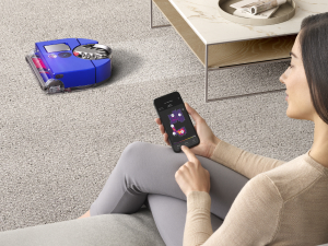 Woman controlling the Dyson 360 Vis Nav with the MyDyson app