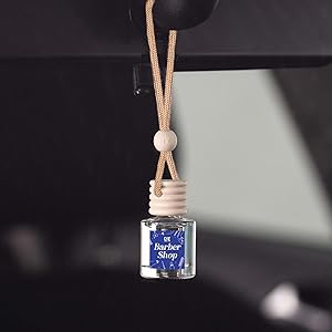 a photo of a hanging car freshener that is barber shop scented