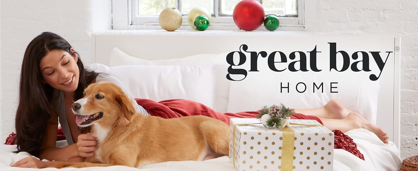 Woman and dog on a bed surrounded by presents